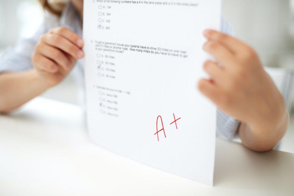 girl with test paper at school